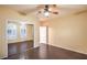 Bright bedroom with a ceiling fan, wood floors, mirrored closet doors, and white door with a window at 1992 Fort Halifax St, Henderson, NV 89052