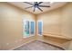 Bedroom with two windows with plantation shutters and a ceiling fan at 1992 Fort Halifax St, Henderson, NV 89052