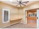 Bonus room with a ceiling fan, wood-look tile flooring, a built-in desk, and natural light at 1992 Fort Halifax St, Henderson, NV 89052