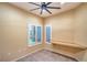 Bright bonus room with a ceiling fan, wood-look tile flooring, and natural light from two windows at 1992 Fort Halifax St, Henderson, NV 89052