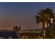 Dusk skyline view with palm trees and solar panels in a desert community at 1992 Fort Halifax St, Henderson, NV 89052