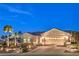 Front exterior with concrete steps, desert landscaping, and three-car garage at 1992 Fort Halifax St, Henderson, NV 89052