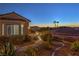 Lovely exterior landscape with winding walkway and exterior stairs at 1992 Fort Halifax St, Henderson, NV 89052