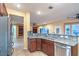 Open kitchen with granite countertops, sink, and stainless steel refrigerator at 1992 Fort Halifax St, Henderson, NV 89052