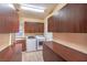 Large laundry room featuring washer, dryer, sink, generous counter space, and abundant cabinet storage at 1992 Fort Halifax St, Henderson, NV 89052