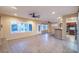 Spacious living room features ceiling fan, tiled floors and rear windows at 1992 Fort Halifax St, Henderson, NV 89052