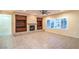 Open-concept living room with tiled floors, fireplace, built-ins, and bright windows at 1992 Fort Halifax St, Henderson, NV 89052
