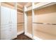 Bright walk-in closet boasts custom shelving, drawers, and sleek hardware for optimal storage and organization at 1992 Fort Halifax St, Henderson, NV 89052