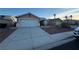Single story house with a wide concrete driveway leading to an attached garage at 213 Beaver Ridge Ave, North Las Vegas, NV 89031