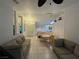 Open-concept living and dining area with tile floors and stylish furniture at 213 Beaver Ridge Ave, North Las Vegas, NV 89031