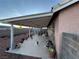 Covered patio and exterior view with block wall offers outdoor living and entertaining area at 213 Beaver Ridge Ave, North Las Vegas, NV 89031