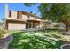 Expansive backyard with a patio, lush green lawn, mature trees, and charming wooden accents at 2233 Marlboro Dr, Henderson, NV 89014