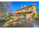 Large grassy backyard featuring mature trees, play structure, fence, and covered patio at 2233 Marlboro Dr, Henderson, NV 89014