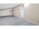 Spacious basement area with blue carpet and wire shelving, offering plenty of storage and organization at 2233 Marlboro Dr, Henderson, NV 89014
