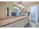 Neutral-toned bathroom featuring a large mirror, vanity with drawers and a shower/tub combination at 2233 Marlboro Dr, Henderson, NV 89014