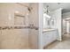 Modern bathroom highlighting a tiled shower, neutral vanity and designer lighting at 2233 Marlboro Dr, Henderson, NV 89014