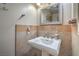Powder room featuring a pedestal sink with neutral color tiles and decorative fixtures at 2233 Marlboro Dr, Henderson, NV 89014