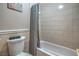 A bathroom featuring a shower/tub combination with tiled walls and a gray shower curtain at 2233 Marlboro Dr, Henderson, NV 89014