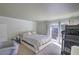 Sunlit bedroom with plush carpet, double bed, access to the backyard, and exercise equipment at 2233 Marlboro Dr, Henderson, NV 89014