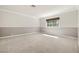 Bright bedroom featuring neutral paint, carpeting, and a large window at 2233 Marlboro Dr, Henderson, NV 89014
