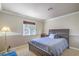 Cozy bedroom featuring a wood-framed bed, soft carpet, and plenty of natural light from the window at 2233 Marlboro Dr, Henderson, NV 89014