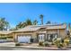 Cozy single-story home with desert landscaping, a two-car garage, and solar panels on the roof at 2233 Marlboro Dr, Henderson, NV 89014