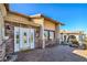 Elegant entrance with a decorative front door and well-manicured landscaping. Includes sitting bench at 2233 Marlboro Dr, Henderson, NV 89014