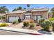 Well-maintained single-story home with desert landscaping, solar panels and brick accents on the facade at 2233 Marlboro Dr, Henderson, NV 89014