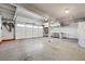 Well-lit garage with ample storage space, including shelving and a refrigerator for convenience at 2233 Marlboro Dr, Henderson, NV 89014