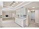 Open kitchen layout with white cabinetry, stainless steel appliances, and tile flooring at 2233 Marlboro Dr, Henderson, NV 89014