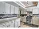 Bright kitchen showcasing white cabinets, stainless steel appliances, tiled backsplash, and ample counter space at 2233 Marlboro Dr, Henderson, NV 89014