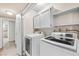 Well-equipped laundry room featuring modern washer and dryer, with convenient storage cabinets above at 2233 Marlboro Dr, Henderson, NV 89014