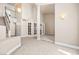 Open floor plan features tile and carpet, stairway and glass doors to a sunroom with ample natural light at 2233 Marlboro Dr, Henderson, NV 89014
