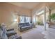 Cozy living room with comfortable seating, a large window, and access to the skylit foyer at 2233 Marlboro Dr, Henderson, NV 89014