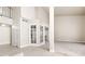 Versatile living space with carpet and tile flooring, glass doors and a stairway to an upper level at 2233 Marlboro Dr, Henderson, NV 89014