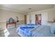 Bright main bedroom featuring neutral walls, blue quilt and a closet with bi-fold doors at 2233 Marlboro Dr, Henderson, NV 89014