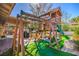 Backyard with a playset structure featuring a slide, climbing area and swings at 2233 Marlboro Dr, Henderson, NV 89014