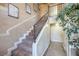 Carpeted staircase featuring decorative stair railing with neutral colored walls at 2233 Marlboro Dr, Henderson, NV 89014
