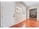 Welcoming foyer with hardwood floors, white door, shutters, and an office with french doors at 2568 Dirleton Pl, Henderson, NV 89044