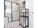 Modern bathroom featuring a glass-enclosed shower, sleek black fixtures, and modern black and white accessories at 2665 Piroli St, Henderson, NV 89044