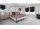 Spacious bedroom featuring a modern four-poster bed, large windows, and ample natural light at 2665 Piroli St, Henderson, NV 89044