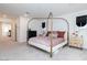 Open bedroom featuring a modern bed, dark dresser, and an attached room that has an additional living space at 2665 Piroli St, Henderson, NV 89044