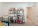 Bedroom with gold etagere shelves, decor, and a glimpse into another room through the open doorway at 2665 Piroli St, Henderson, NV 89044