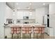 Modern kitchen featuring white cabinets, quartz countertops, stainless steel appliances, and bar stool seating at 2665 Piroli St, Henderson, NV 89044