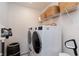 Functional laundry room featuring a modern washer and dryer with shelving and storage baskets at 2665 Piroli St, Henderson, NV 89044