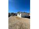Expansive backyard with a covered carport attached to the house, ready for landscaping at 2705 Howard Dr, Las Vegas, NV 89104