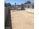 Wide backyard with fence, concrete walkway and direct access to an open carport area at 2705 Howard Dr, Las Vegas, NV 89104