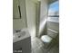 Bright bathroom featuring a vanity with sink, toilet, and window at 2705 Howard Dr, Las Vegas, NV 89104