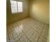 Bedroom showcasing tile flooring, light walls, and natural light from a window at 2705 Howard Dr, Las Vegas, NV 89104