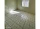 Bedroom showcasing tile flooring, light walls, and natural light from a window at 2705 Howard Dr, Las Vegas, NV 89104